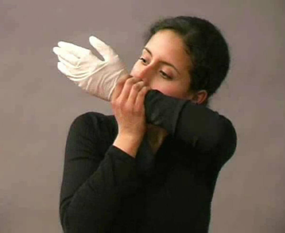 Performance documentation showing a person inflating a white latex glove using their breath.